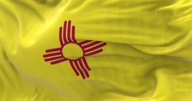 Detail of the New Mexico state flag waving. Red sun, symbol of the Zia people, displayed on a yellow background.Selective focus. 3d render animation. Slow motion loop. Close-up