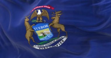 Michigan state flag waving. Dark blue flag with state coat of arms featuring an eagle, an elk and a moose. 3d render animation. Selective focus. Slow motion loop. Close-up. Textured fabric background