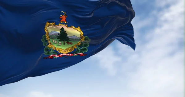 The Vermont state flag fluttering in the wind on a clear day. Coat of arms and motto Freedom and Unity on a blue background. 3D illustration render. Rippled textile. American Federate state