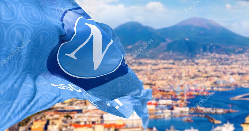 Naples, IT, March 2023: Flag of Napoli football team waving with the Bay of Naples and Mount Vesuvius blurred in the background. Illustrative editorial 3d illustration render