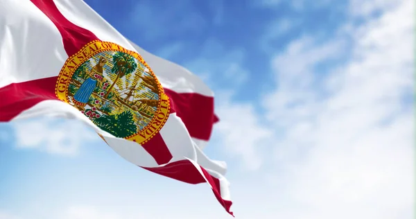 stock image Close-up view of the Florida state flag waving in the wind on a clear day. Red saltire on white with the state seal in the center. 3d illustration render. Selective focus.