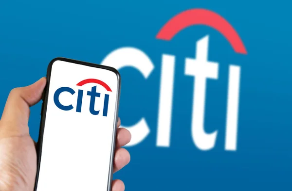 2023年3月 ニューヨーク市のロゴ入り携帯電話を画面にかざす 青い背景に街のロゴがぼやけている シティはアメリカの多国籍投資銀行である 挿絵画集 — ストック写真