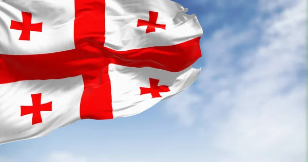 Georgian national flag waving in the wind on a clear day. White with a red cross and four smaller red crosses in the corners 3d illustration render. Fluttering fabric.