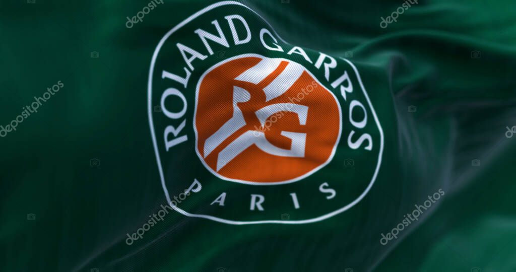 Paris, FR, Apr. 2023: Green flag with Roland Garros logo waving in the wind. French Open is a major tennis tournament scheduled in late May each year. Illustrative editorial 3d illustration render