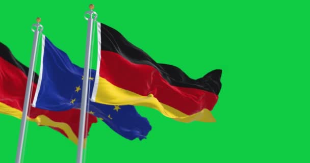 ドイツと欧州連合の旗が緑の背景に孤立して手を振っている シームレスな3Dレンダリングアニメーション 緑の画面だ クロマキー スローモーションループ 選択的フォーカス 4K解像度 — ストック動画