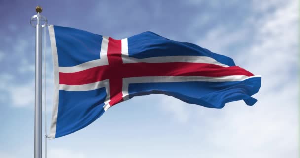 アイスランド国旗が風になびく 白い縁の赤い北欧の十字の青い旗 シームレスな3Dレンダリングアニメーション スローモーションループ フラッタリング生地 接近中だ — ストック動画