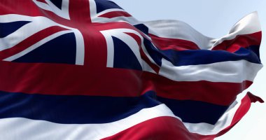 Hawaii eyalet bayrağının yakınında açık bir günde rüzgarda dalgalanan. Sekiz yatay çizgi beyaz, kırmızı, mavi, kanton3d resimli Union Jack. Çırpınan kumaş
