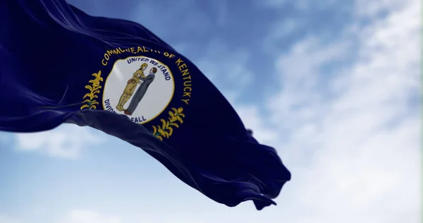 The US state flag of Kentucky waving. Kentucky flag features state seal: two men embracing, motto 