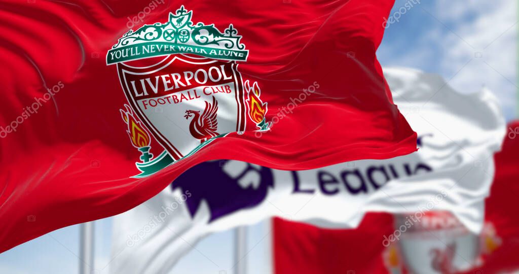 Liverpool, UK; seot. 14 2023: Liverpool Football Club and Premier League flags waving together on a clear day. Illustrative editorial 3d illustration render. Fluttering fabric. Selective focus