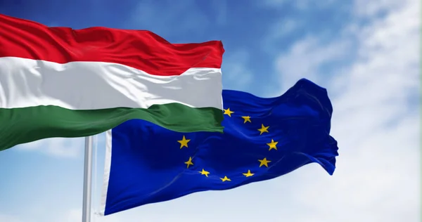 Flags of Hungary and the European Union fluttering together on a clear day. Hungary became a member of the European Union on 2004. 3d illustration render.