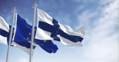 Finlandiya 'nın ulusal bayrakları açık bir günde Avrupa Birliği bayrağıyla dalgalanır. Kusursuz 3 boyutlu animasyon. Yavaş çekim döngüsü. Seçici odaklanma. 4k