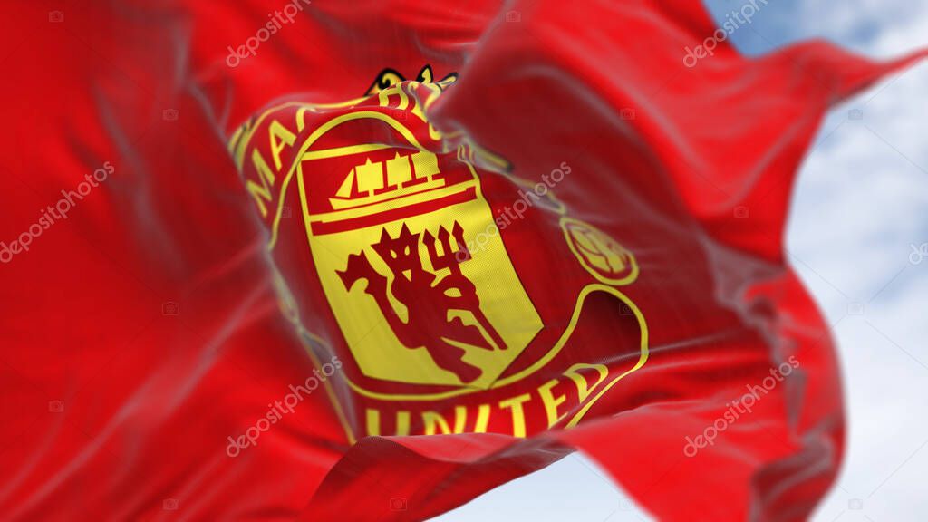 Manchester, UK, Oct. 2 2023: Close-up of Manchester United Football Club flag waving on a clear day. Premier League pro team. Illustrative editorial 3d illustration render. Selective focus