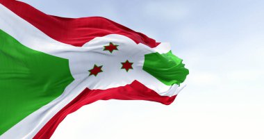 Burundi 'nin ulusal bayrağı açık havada dalgalanıyor. Kırmızı ve yeşil bölümlere bölünen beyaz köşegen, ortada üç yeşil yıldız. 3D illüstrasyon canlandırıcı. Kanat çırpan kumaş. Seçici odak