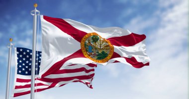 Flags of Florida and United States waving in the wind on a clear day. US state flag. Pride and patriotism concept. 3d illustration render. Fluttering textile clipart