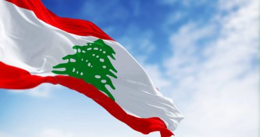 Lebanon national flag waving in the wind on a clear day. Three horizontal stripes of red, white, red, with a green Lebanese cedar in center. 3d illustration render. Rippling fabric. Selective focus clipart