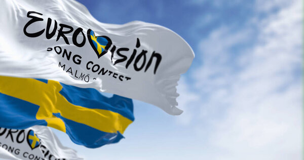 Malm, SE, Oct. 25 2023: Eurovision Song Contest 2024 and swedish flags waving on a clear day. The 2024 edition will take place in Malmo on may. Illustrative editorial 3d illustration render