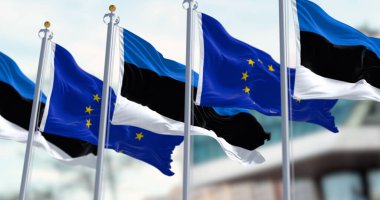 The flags of Estonia and the European Union waving together on a clear day. Estonia became a member of the European Union on May 1, 2004. Realistic 3d illustration. International treaty and diplomacy