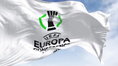 Atina, GR, 20 Aralık 2023: Açık bir günde UEFA Avrupa Konferans Ligi bayrağının yakın çekimi. Avrupa kulüpleri için yıllık futbol kulübü yarışması. Kusursuz 3 boyutlu animasyon. Yavaş çekim döngüsü