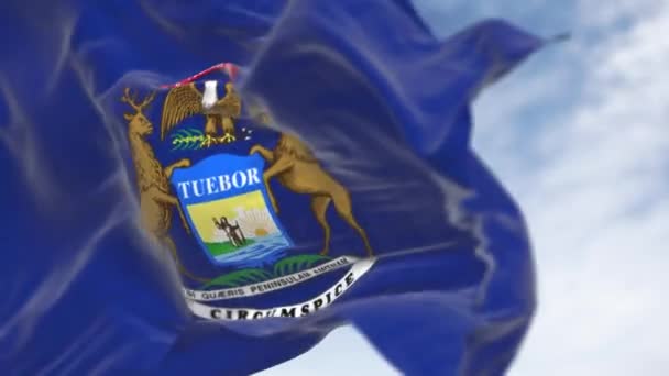 ミシガン州の国旗が風に揺れている イーグル エルカ ムースをフィーチャーした国章付きのダークブルーの旗 シームレス3Dレンダリングアニメーション スローモーションループ 選択的なフォーカス — ストック動画