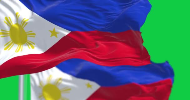 Close Duas Bandeiras Nacionais Das Filipinas Acenando Isoladas Fundo Verde — Vídeo de Stock