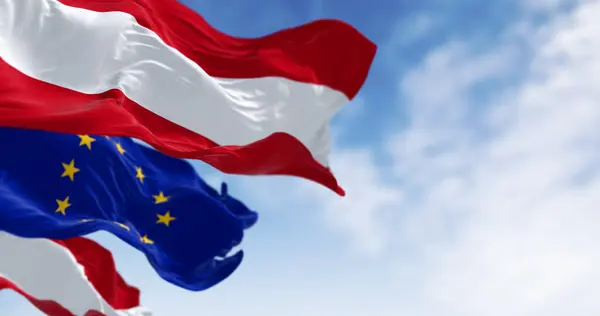 stock image Austria and European Union flags waving together on a clear day. Democracy and politics. European country. 3d illustration render. Fluttering fabric. Selective focus