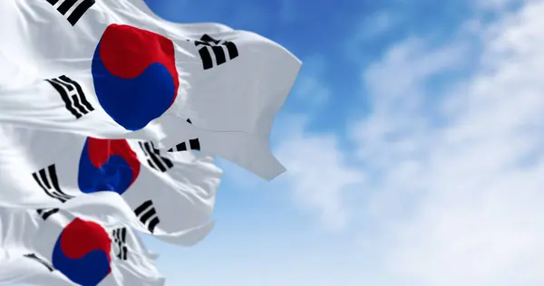 stock image Close-up of South Korea national flags waving in the wind. White field, red-blue Taegeuk center, four black trigrams. 3d illustration render. Fluttering fabric. Textured rippled background