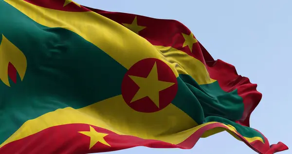 stock image Close-up of national flag of Grenada waving in the wind on a clear day. Country in the southeastern Caribbean Sea. 3D illustration render. Rippling fabric.