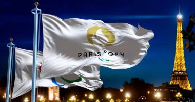 Paris, FR, Sept 1st 2024: Paris 2024 and the Paralympics flags waving in the wind with blurred night Paris skyline in the background at night. 3d render illustration. Illustrative editorial clipart