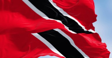 Trinidad and Tobago national flag waving on a clear day. The Republic of Trinidad and Tobago is an island state in the Caribbean. 3d illustration render. Rippled fabric. Selective focus. Close-up