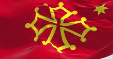 Occitanie bölgesinde rüzgarda dalgalanan bayrağın yakın çekimi. Korsika hariç Fransa 'nın idari bölgesi. Kusursuz 3 boyutlu animasyon. Yavaş çekim döngüsü.