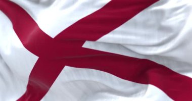 Güneşli bir günde Alabama eyalet bayrağının yakın çekimi. Alabama bayrağında beyaz bir tarlada kırmızı bir haç var. Kusursuz 3 boyutlu animasyon. Yavaş çekim döngüsü. Seçici odak.