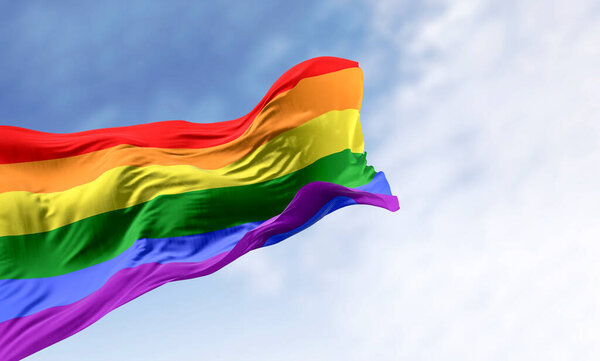 Rainbow flag waving on a clear day. Multicolored flag with stripes in the colors of the rainbow, often used as a symbol of LGBT pride. 3d illustration render. Fluttering fabric