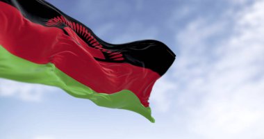 Malawi bayrağının gerçekçi yakın planında yükselen güneş, mavi bir gökyüzü altında dalgalanan, ulusal gurur, özgürlük ve birliği sembolize eden. 3B kumaş dokusu çizimi.