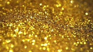 Şenlikli altın pullar üzerine Bokeh.