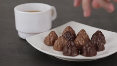 female hand takes chocolate candy