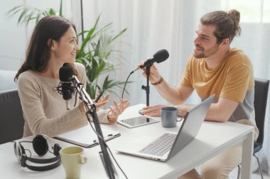 Young professional speaker conducting a live podcast interview, communication and media concept