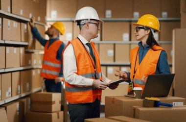 Warehouse workers checking orders on the laptop, logistics and shipping concept clipart