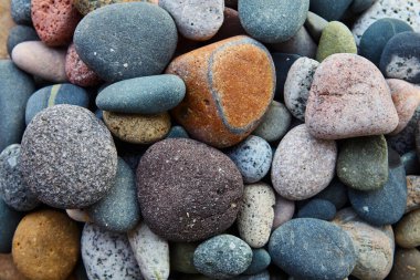 Nature's artwork, right at the shore  Each stone shaped by the waves, each one unique. Theres something peaceful in these simple detailsa reminder that beauty is found in every corner of the beach.