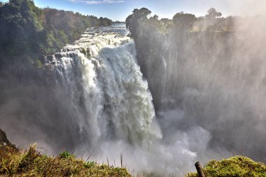 Victoria Falls, one of the Seven Natural Wonders of the World, is a breathtaking sight located on the border between Zambia and Zimbabwe. Known locally as 