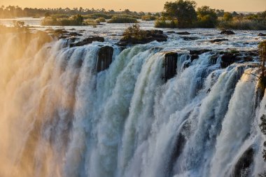 Victoria Falls, one of the Seven Natural Wonders of the World, is a breathtaking sight located on the border between Zambia and Zimbabwe. Known locally as 