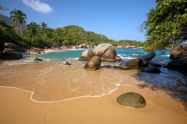 Tayrona Ulusal Parkı 'nın el değmemiş plajları sizi, bereketli tropikal ormanların çerçevelediği turkuaz suların altın kumlarla buluştuğu bir dünyaya davet ediyor. Gerçek bir Kolombiya mücevheri. .