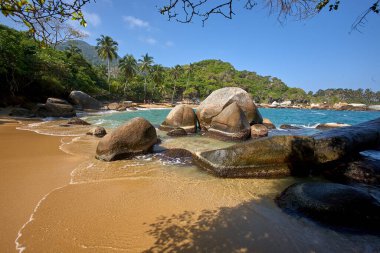 Tayrona Ulusal Parkı 'nın el değmemiş plajları sizi, bereketli tropikal ormanların çerçevelediği turkuaz suların altın kumlarla buluştuğu bir dünyaya davet ediyor. Gerçek bir Kolombiya mücevheri. .