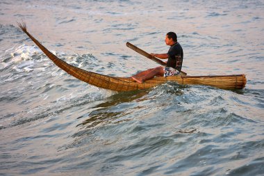 Riding the waves of history, surfers embrace an ancient tradition on caballitos de totorareed boats used by the Moche and Chim civilizations over 3,000 years ago. clipart