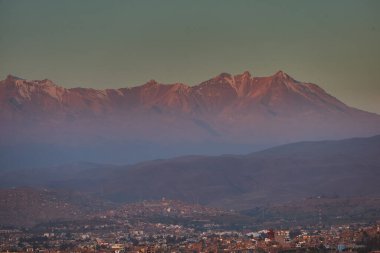 Pichu Pichu 'nun antik silueti güneş alevler içinde batarken Arequipa' yı izler. And Dağlarının nefesini tuttuğu ve ışığın gökyüzüne şiir yazdığı bir an.
