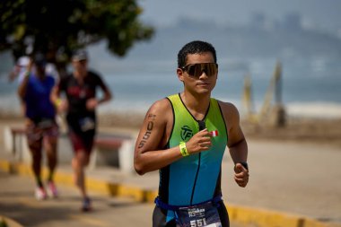 Demir Adam 70.3 Lima 'nın son turlarında koşan sporcular, sadece hayaller peşinde koşmakla kalmaz, aynı zamanda yaşarlar da. Gözyaşları, ter ve kırılmaz ruh bitiş çizgisine giden yolu işaretler..