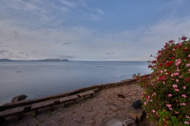 Capachica Yarımadası 'nda, çiçeklerin sıcacık göl kenarındaki bir evi ve taş bankları kucakladığı huzurlu bir köşe sizi Titicaca Gölü' nün muazzam güzelliğini durup takdir etmeye davet ediyor. Puno Peru