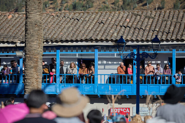 balconies adorned with blue woodwork, locals and visitors gather to witness the dazzling dances, music, and faith that honor the Virgen del Carmen.