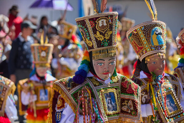 the Qhapaq Chunchu dancers of Paucartambo embody the Amazonian spirit during the Virgen del Carmen festivities. Their colorful costumes, feathered crowns, and striking masks reflect centuries of tradition, devotion, and cultural identity