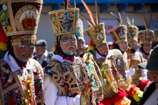 the Qhapaq Chunchu dancers of Paucartambo embody the Amazonian spirit during the Virgen del Carmen festivities. Their colorful costumes, feathered crowns, and striking masks reflect centuries of tradition, devotion, and cultural identity