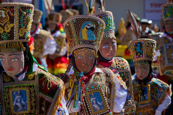 the Qhapaq Chunchu dancers of Paucartambo embody the Amazonian spirit during the Virgen del Carmen festivities. Their colorful costumes, feathered crowns, and striking masks reflect centuries of tradition, devotion, and cultural identity